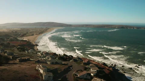 Winding road cutting through beautiful neighborhood on the shore of the ocean Stock Footage 163991180