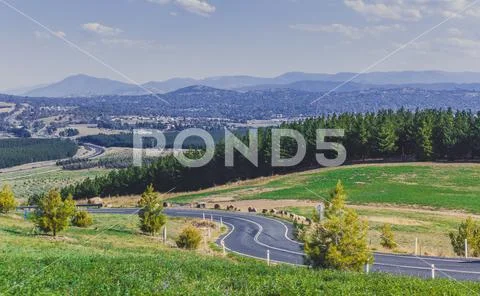 Winding road, forest and mountains - view from National Arboretum Canberra, A Stock Photos
