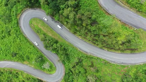Winding road in the forest The top view of the beautiful Aerial view of asphalt  Stock Footage 142298411
