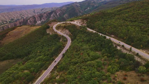 Winding road green forests rolling hills mountains aerial view   Stock Footage 304459565