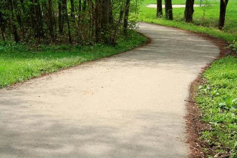 Winding road in a park in spring Stock Photos