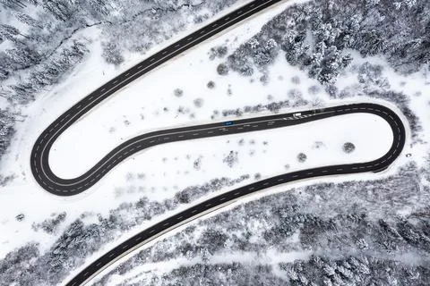 Winding road Serpentine Switchbacks winter snow season aerial photo Stock Photos