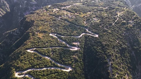 Winding road through deep mountain gorge with river below, Tzoumerka, Epirus, Stock Footage 341871690