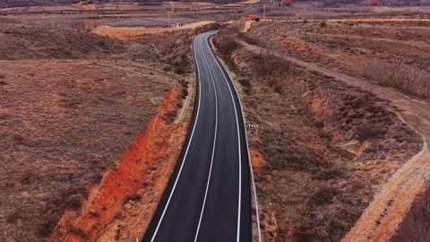 Winding road through dry landscape in Spain during daylight 스톡 동영상 333112810