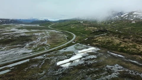 Winding road through a flat Valley, cloudy day, Aerial shot Stock Footage 289565951