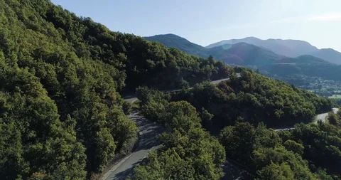 Winding road through forest in mountain area in the Pyrenees drone aerial 4k Stock Footage 125754830