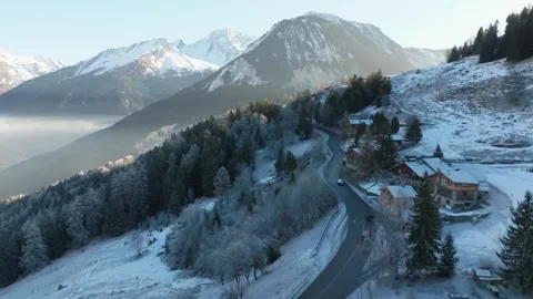 Winding Road Through Snowy Alpine Landscape with Mountain Views 動画素材 334241496