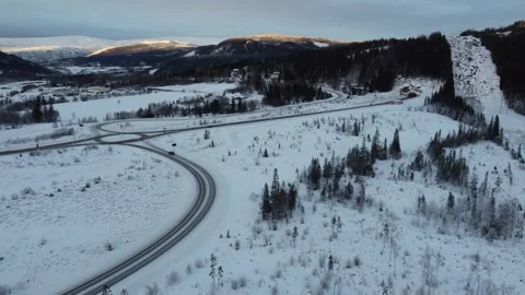 Winding road through snowy landscape in Norway during winter Stock Footage 328191683