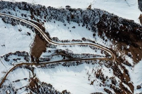 Winding road through a winter forest. Stock Photos