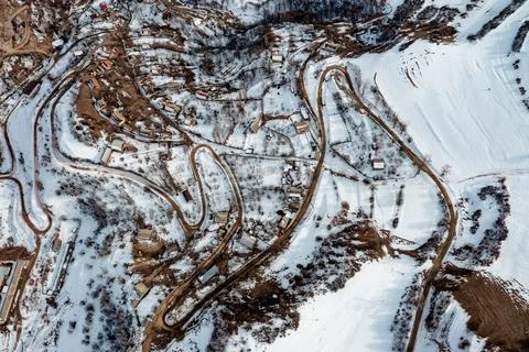 Winding road through a winter forest. Stock Photos