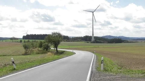Winding road with wind power plants Stock Footage 345149324