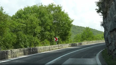 Winding serpentine road cutting through Croatia mountains Stock Footage 299894564
