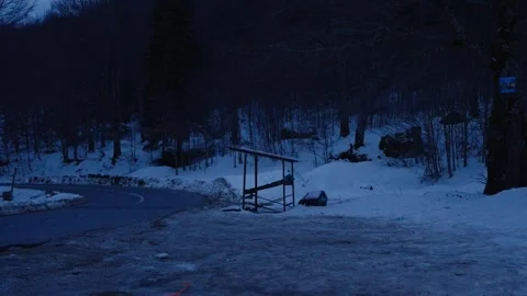 Winding Snowy Mountain Road with Empty Wooden Stall 4K Stock Footage 328261418