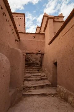 Winding stone path between adobe buildings in a village Aït Benhaddou Stock Photos