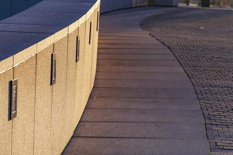 Winding stone path with a curb in the park. Stock Photos