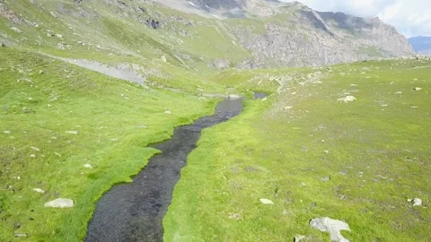 A winding stream flowing through a valley in Pyrenees, France Stock Footage 301392949