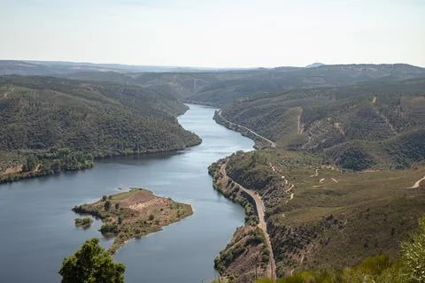 The winding Tejo River flowing through lush green hills Stock Photos
