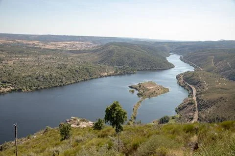 The winding Tejo River flowing through lush green hills Stock Photos