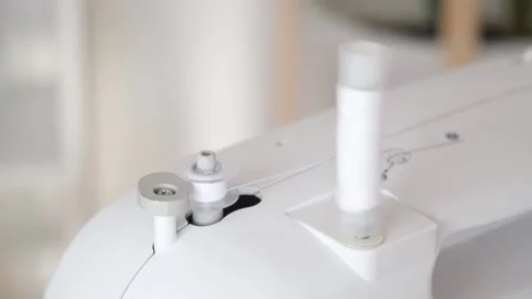 Winding white threads on bobbin sewing machine Stock Footage 203851788