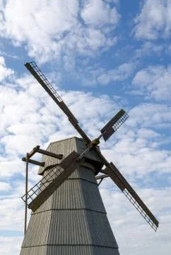 Windmill against the blue sky with clouds Stock Photos