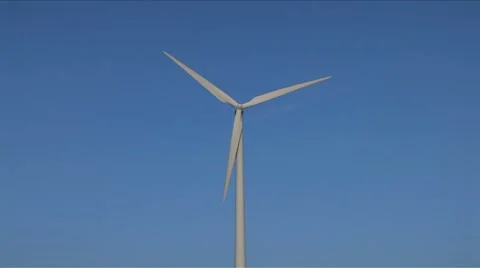 Windmill against blue sky wide Stock Footage