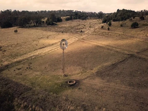 Windmill and Paddock gimbal zoom out GRADED Stock Footage 78502046