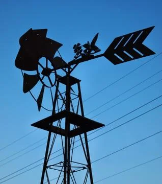 Windmill and power lines Stock Photos