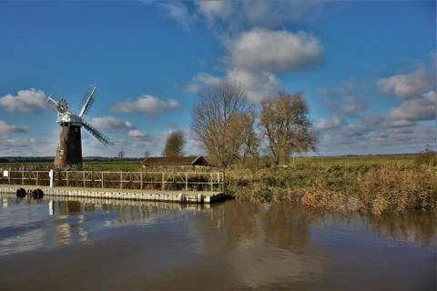 Windmill and river Фото