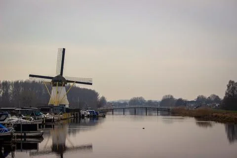 Windmill and small harbor Stock Photos