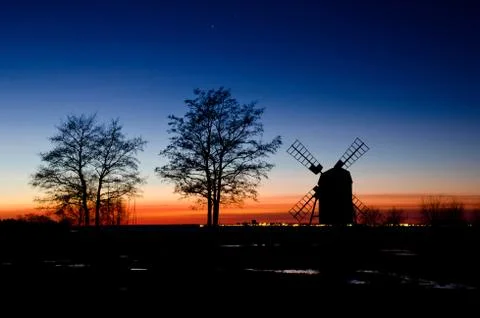 Windmill and trees in sunset Stock Photos