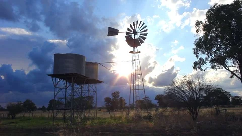 Windmill And Water Tanks At Sunset Stock Footage