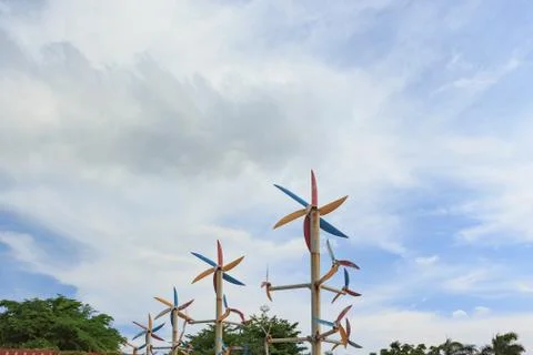 Windmill around trees with blue sky background Stock Photos
