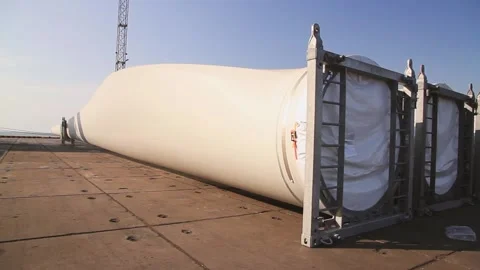 Windmill blades lie on pier after shipment. Wind turbine propeller for wind gene Stock Footage 224748680