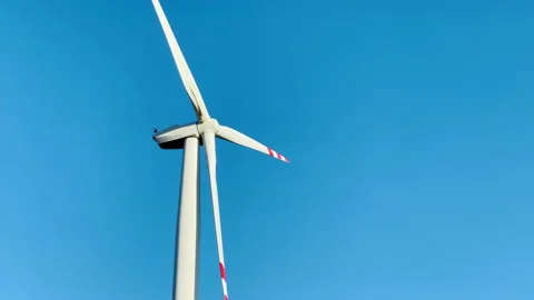Windmill on blue sky background, generation of electricity from wind energy. 库存影片 235627720