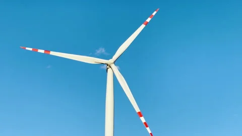 Windmill on blue sky background, generation of electricity from wind energy. Video stock 235627896