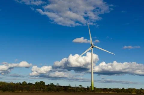 Windmill by a blue sky with white clouds by fall season Stock Photos