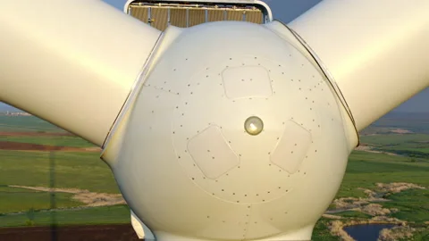 Windmill close-up, wind power plant from above, green meadow and blue sky Stock Footage 131250213
