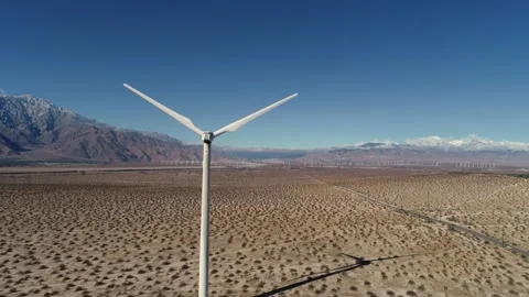 Windmill in the Coachella Valley Snow Capped Mountains Drone Stock Footage 147163712