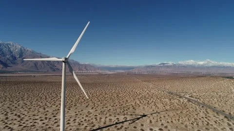 Windmill in the Coachella Valley Snow Capped Mountains Drone Shot Stock Footage 147163718
