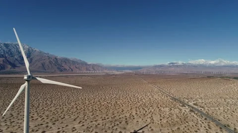 Windmill in the Coachella Valley Snow Capped Mountains Drone Shot Stock Footage 147163868