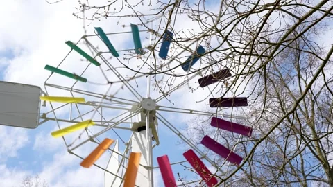 A windmill with colorful blades is on a pole Stock Footage 306762522
