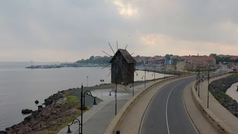 Windmill. Dam road to the old city. Sea, dawn. Aerial photography. 스톡 동영상 121504746