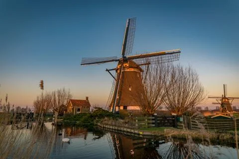 Windmill during sunset at the river Rotte in Holland Foto stock