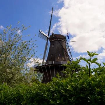 Windmill with Dutch flag on it Stock Photos