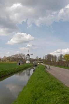 Windmill in Dutch landscape Stock Photos