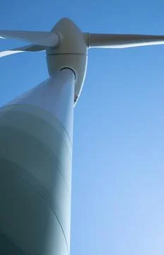 Windmill for electricity generation the background of a blue sky. Stock Photos