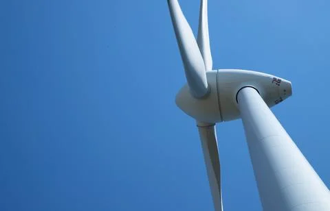 Windmill for electricity generation the background of a blue sky. Stock Photos