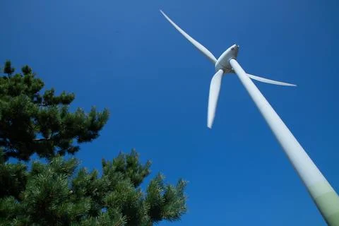 Windmill for electricity generation the background of a blue sky. Stock Photos