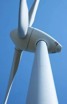 Windmill for electricity generation the background of a blue sky. Stock Photos