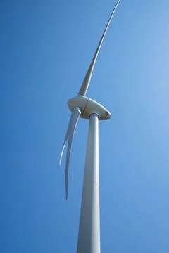 Windmill for electricity generation the background of a blue sky. Stock Photos